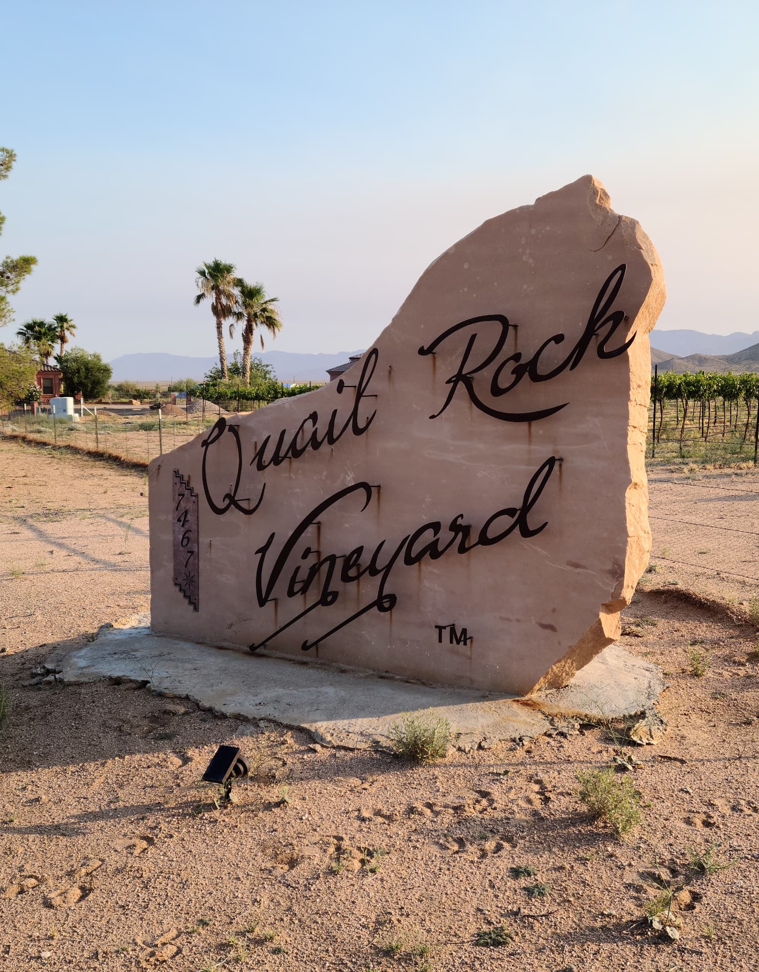 Carved stone entrance sign reading Quail Rock Vineyard at the property gate